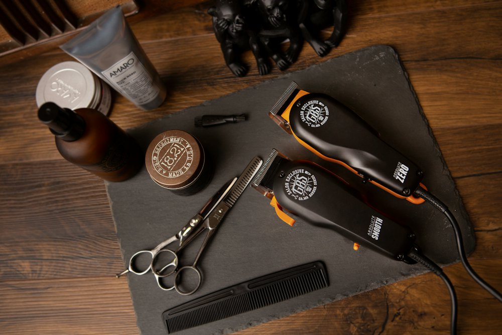 Clippers, scissors and grooming products on a wooden counter