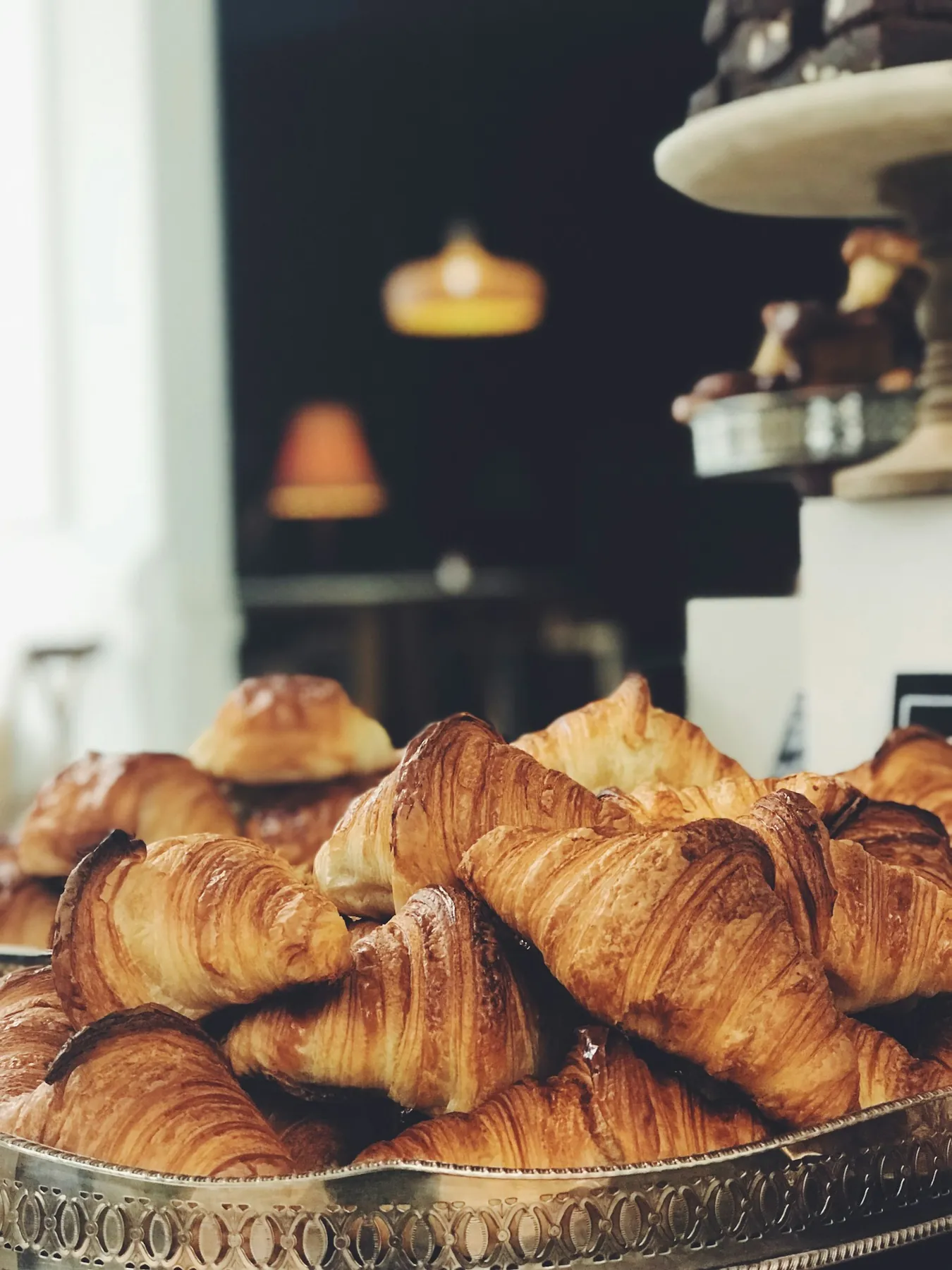 Tray of golden croissants on the café counter